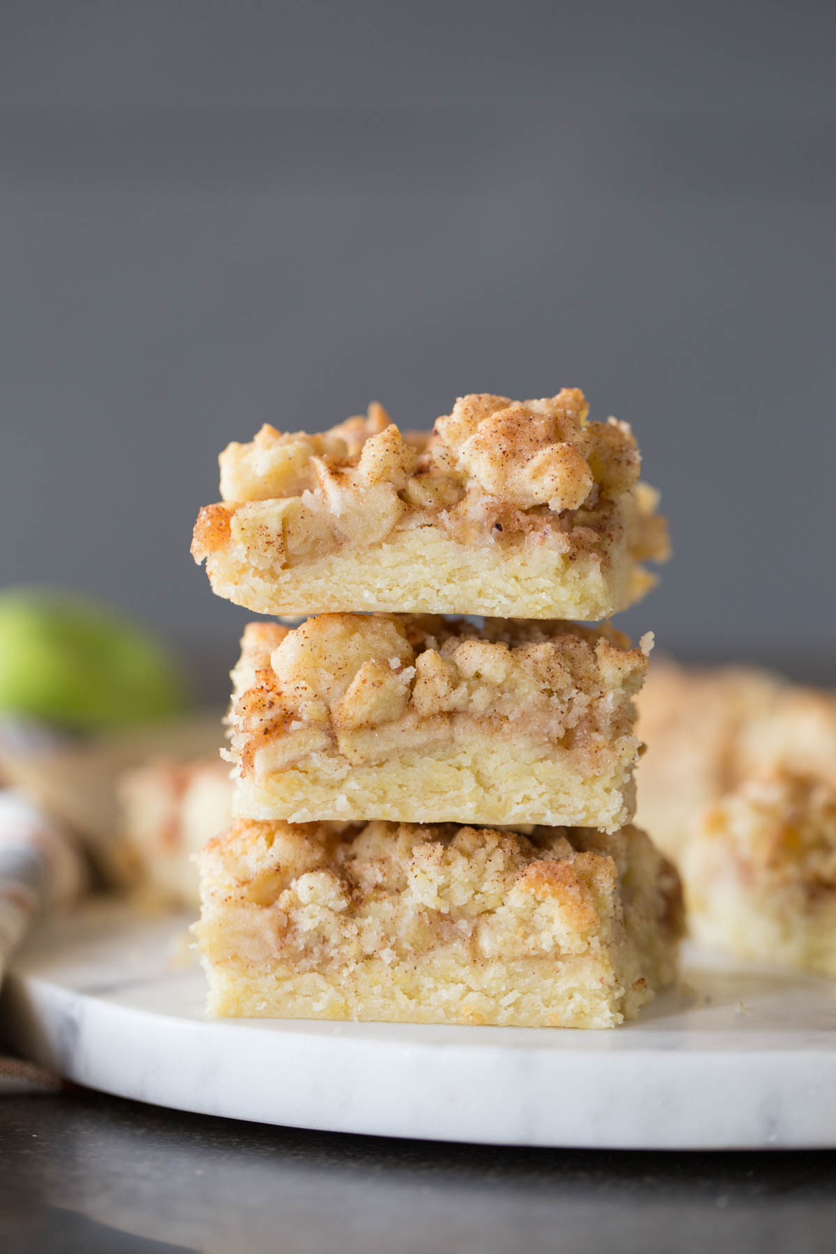 Three Apple Pie Crumb Bars stacked on top of each other.  