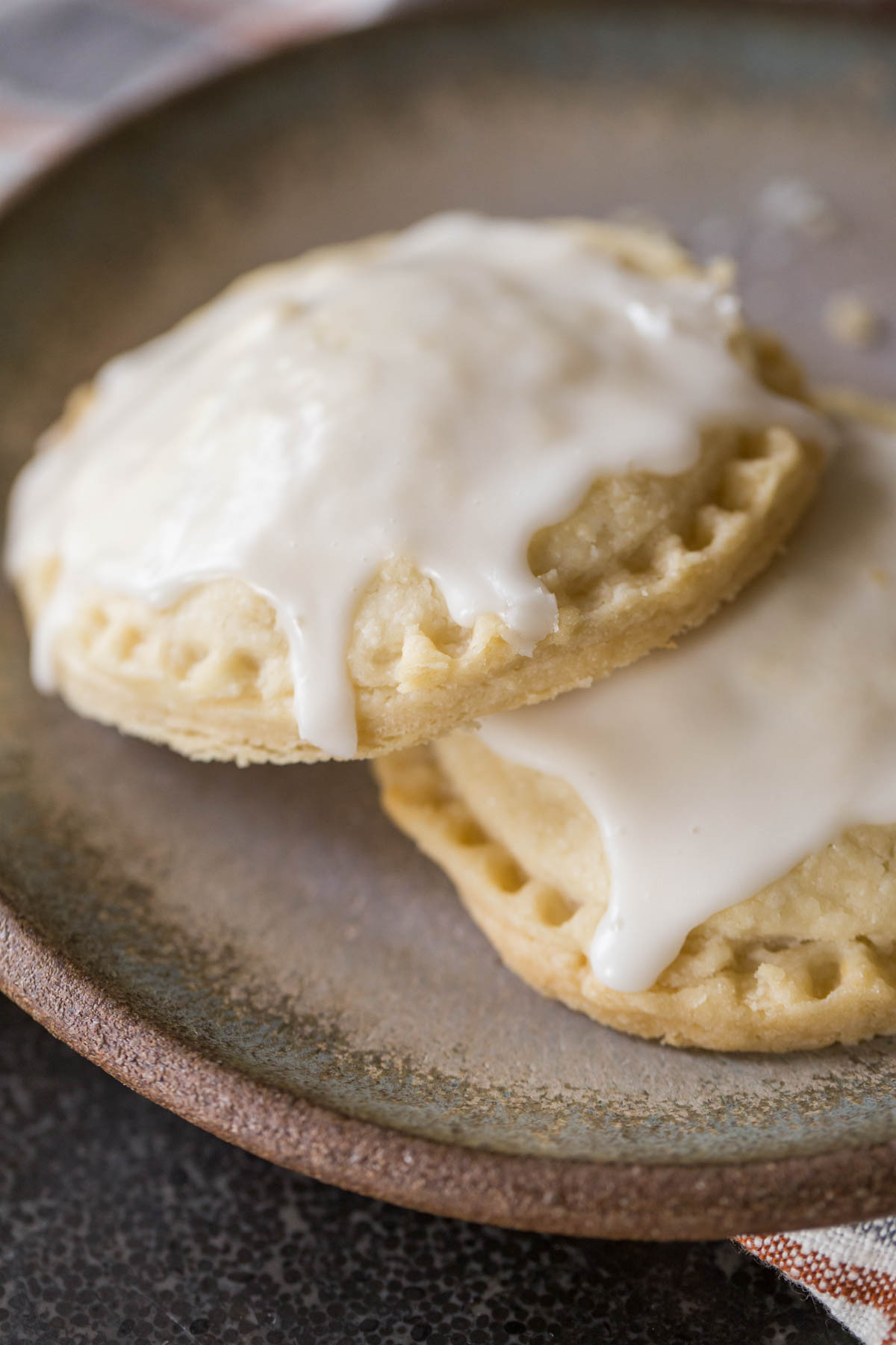 Two Glazed Pumpkin Hand Pies on a plate. 