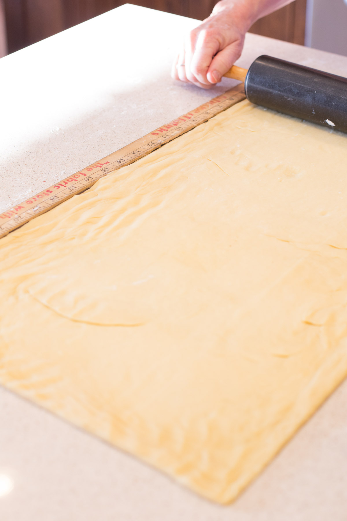 Dough for the Buttery Almond Bear Claws being rolled into a rectangle. 