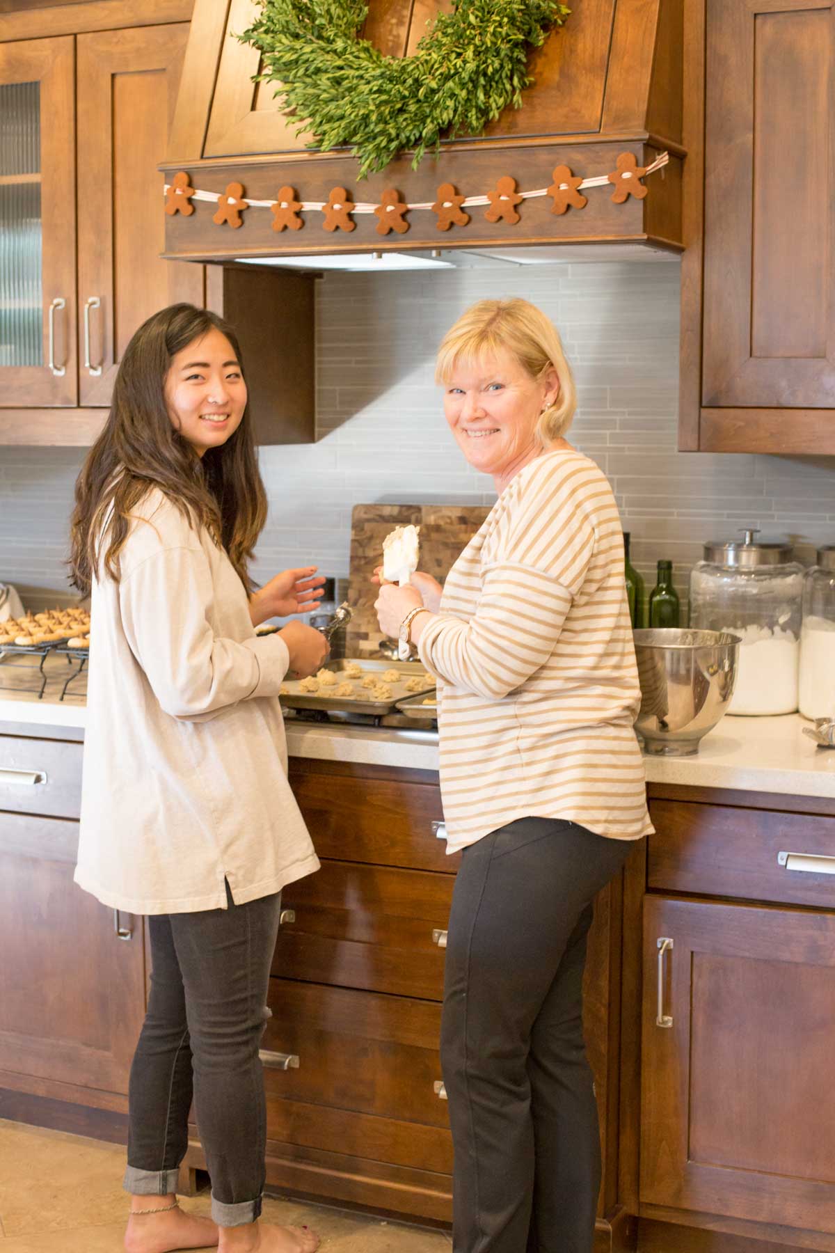 Two ladies in the kitchen making cookies. 