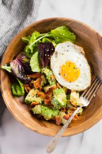We've got creamy avocado and baby greens dressed with freshly squeezed lemon juice and sprinkled with crispy bacon and Everything But the Bagel Seasoning. Start your morning off right!