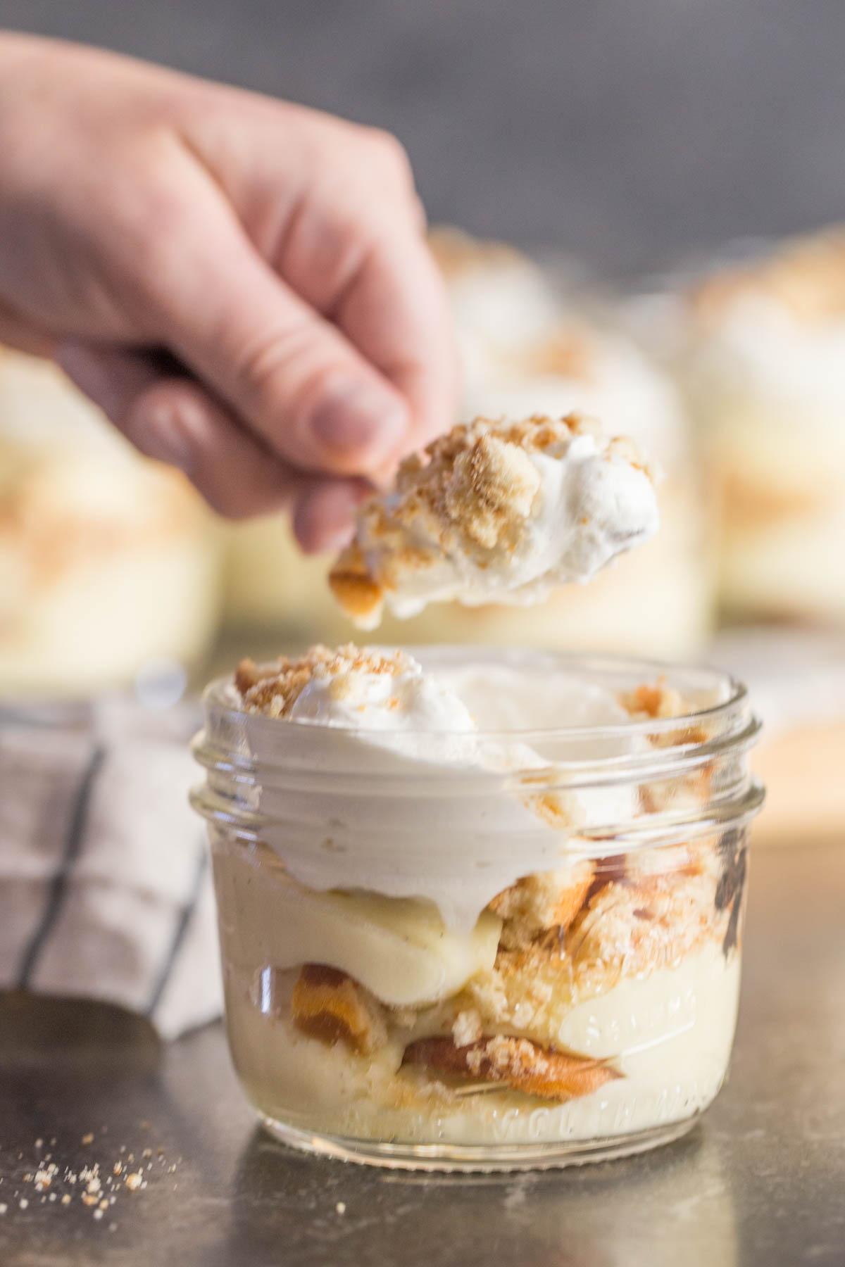 Spoonful of banana pudding above jar