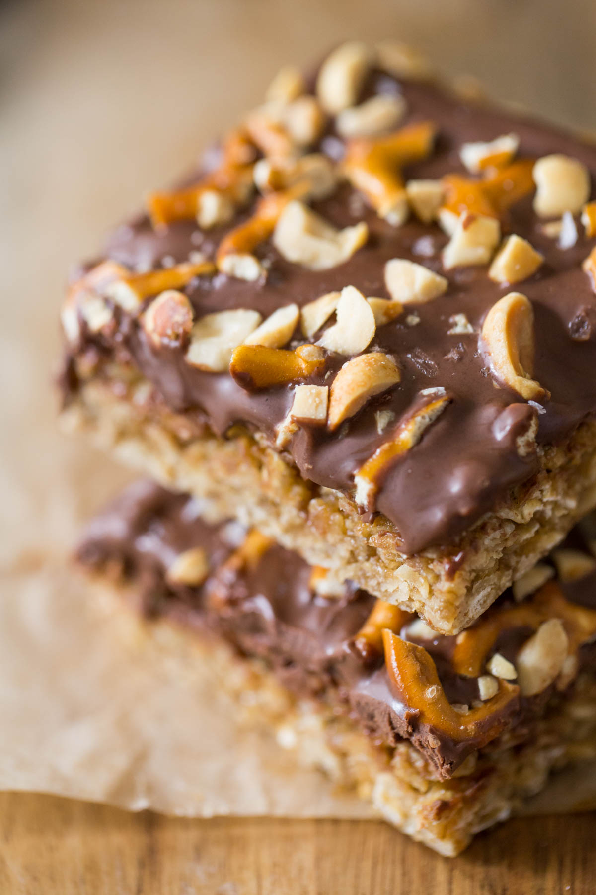 A close up view of the peanut and pretzel toppings on a stack of Oh Henry Bars