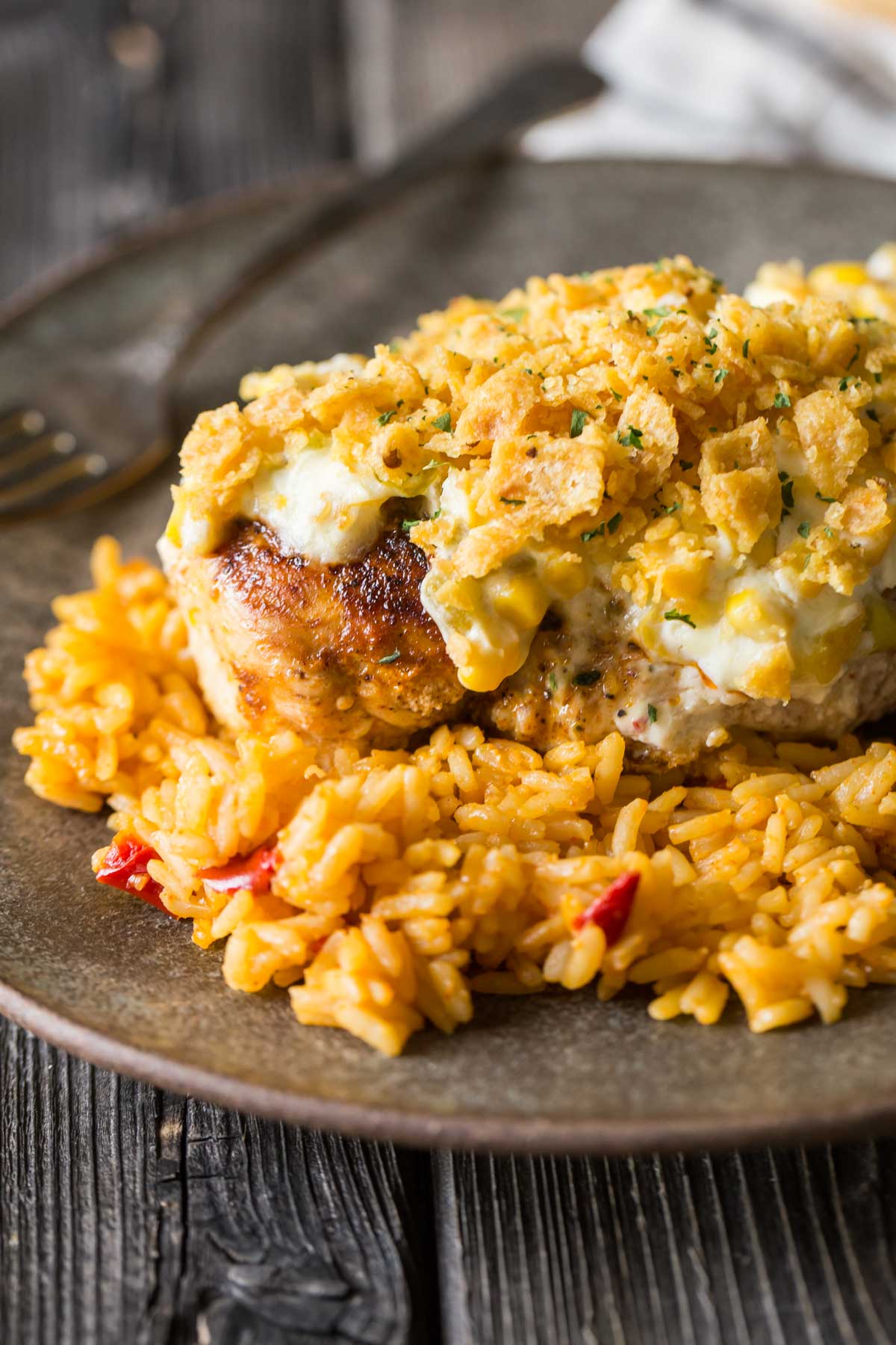 Close up of Creamy Cheesy Frito Chicken Skillet served over rice on a plate. 