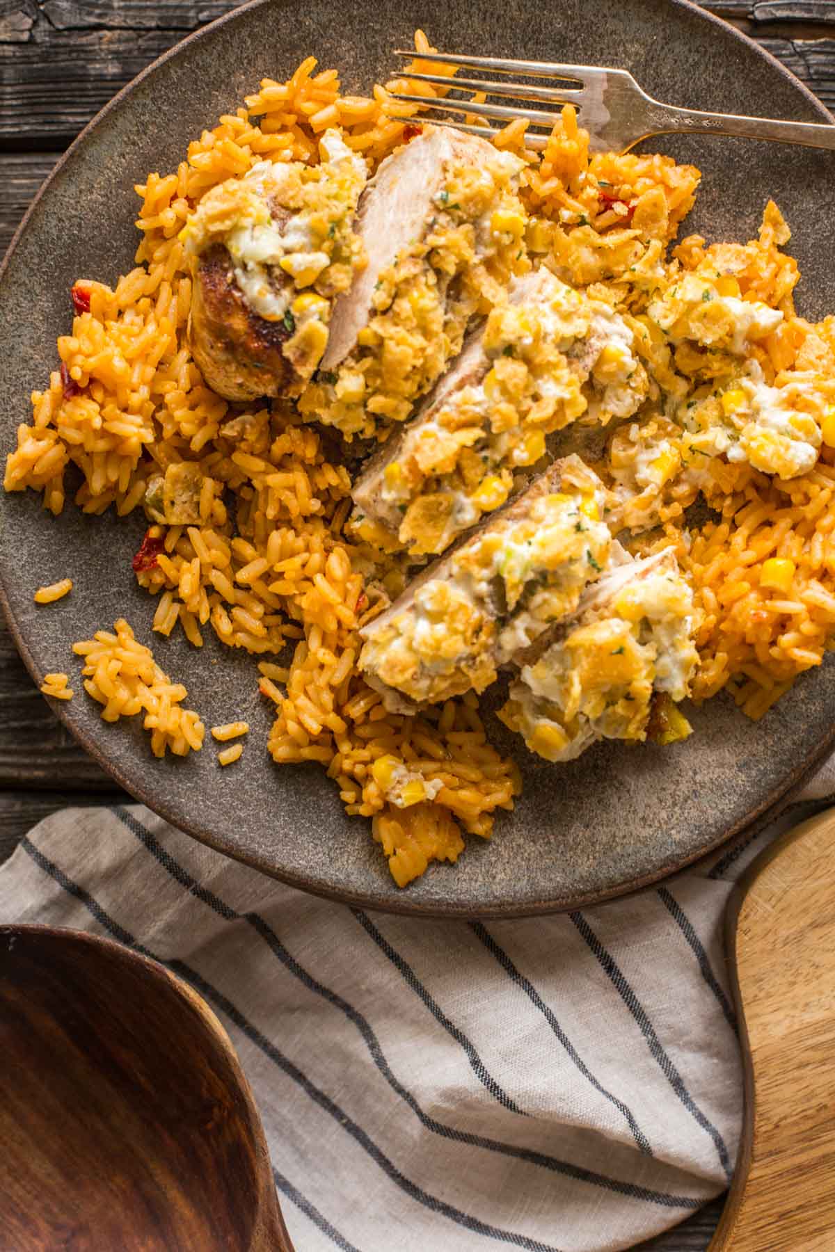 Sliced Creamy Cheesy Frito Chicken Skillet served on a bed of rice. 