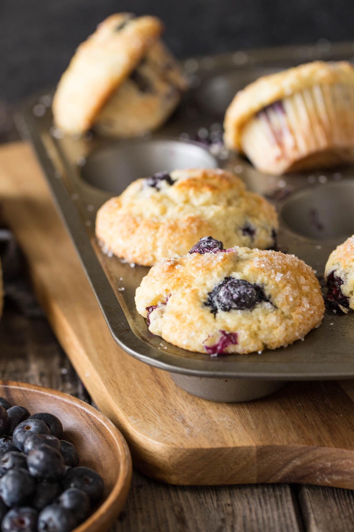 A close up view of Best Ever Buttermilk Blueberry Muffins in a muffin pan. 