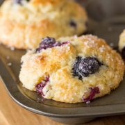 A close up view of Best Ever Buttermilk Blueberry Muffins in a muffin pan.