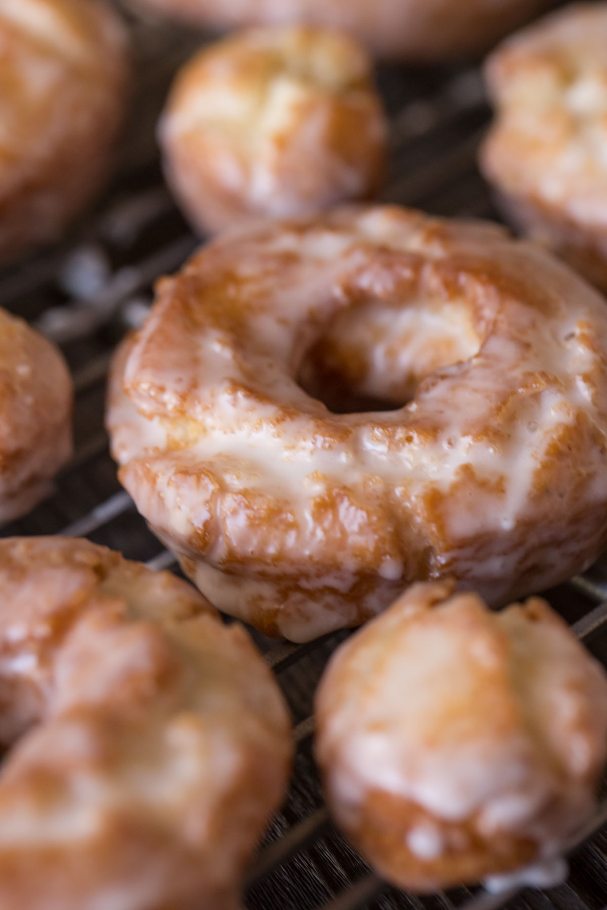 Close up view of an Old Fashioned Buttermilk Donut on a baking rack. 