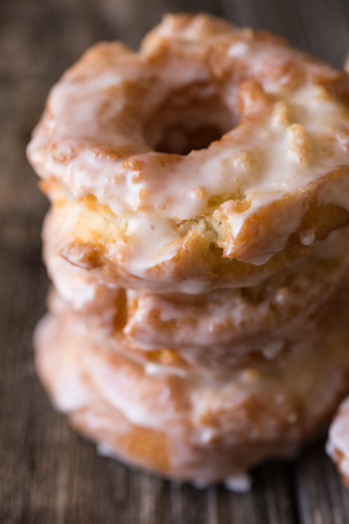 Close up picture of Old Fashioned Buttermilk Donuts with a thick glaze in a stack. 
