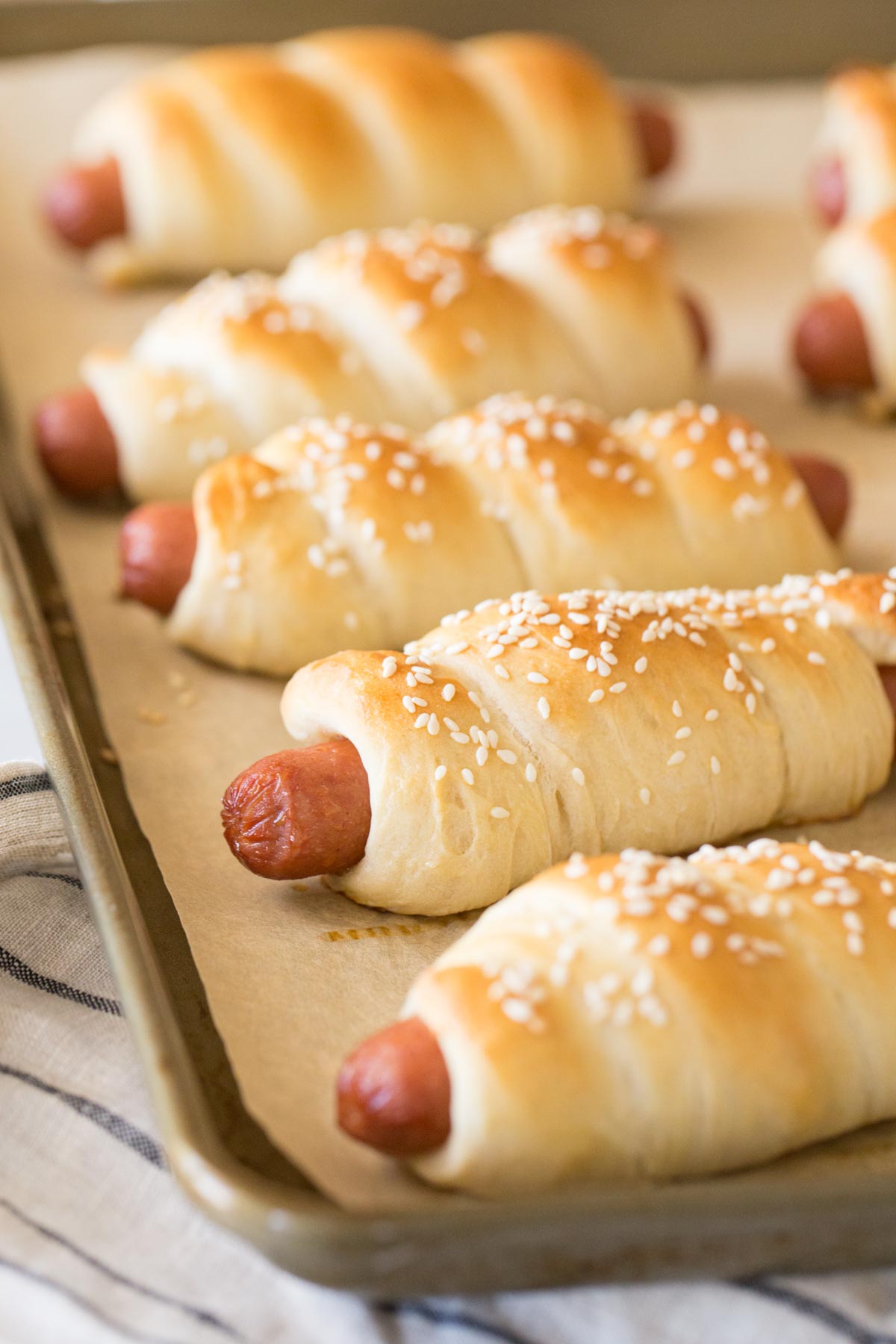 Homemade Pigs in a Blanket on a baking sheet. 