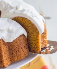 A close up view of a slice of pumpkin spice bundt cake on a cake serve.