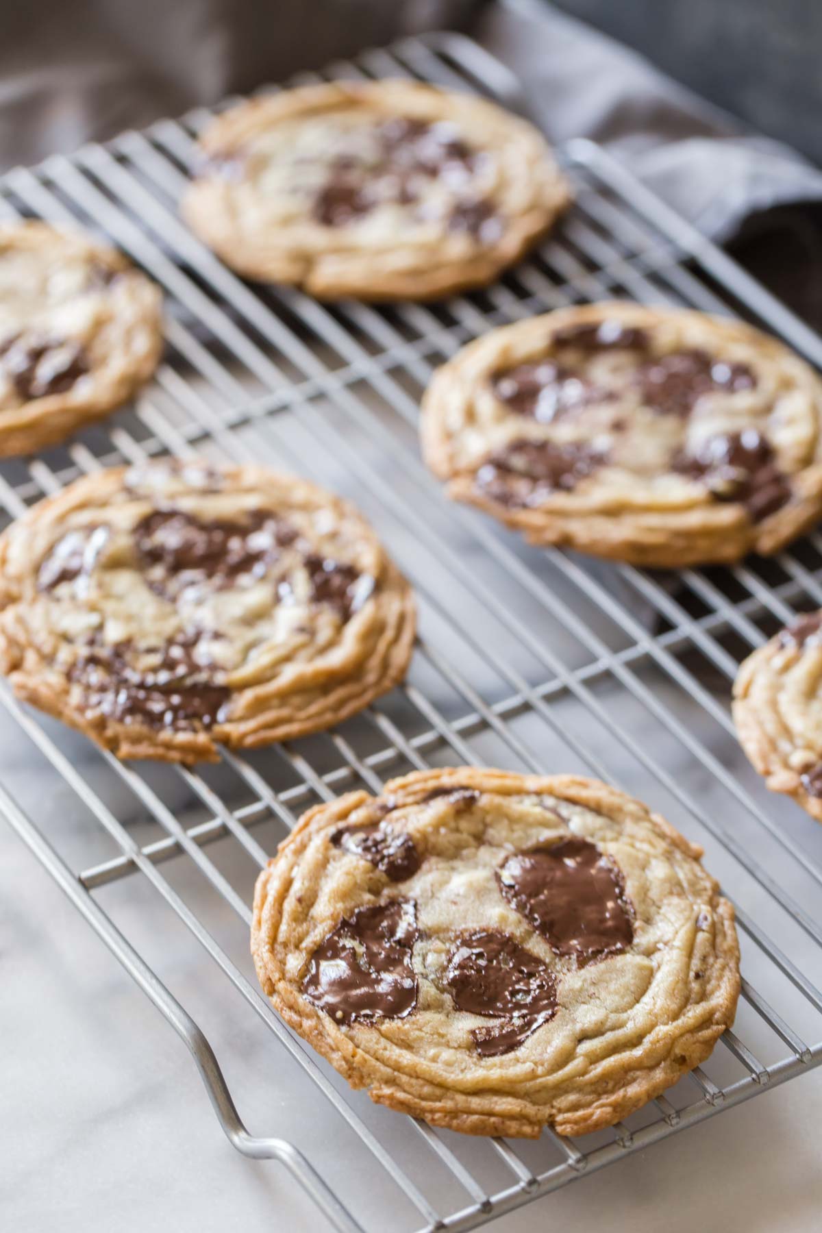 Toffee Almond Chocolate Chunk Cookies on a cooling rack. 