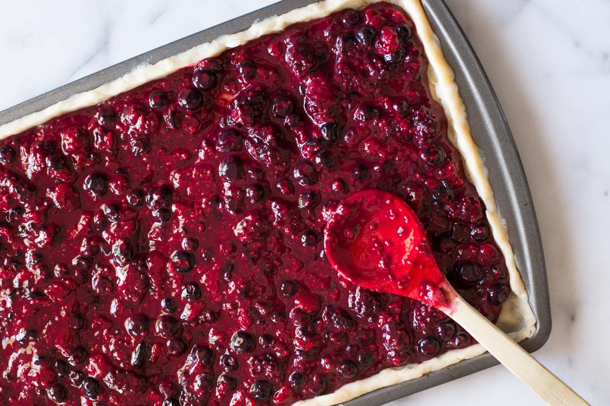 Triple Berry Slab filled with berry filling, ready to be topped with a top crust. 