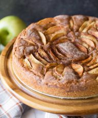 Front view of Apple Cider Cake on a wooden cake stand.