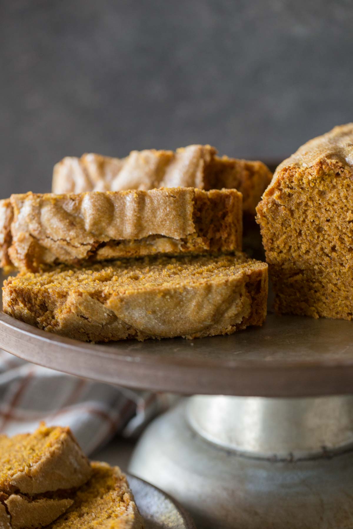 Slices of Easy Pumpkin Bread on a metal cake stand. 