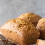 Applesauce Zucchini Bread mini loaf on a grey background.