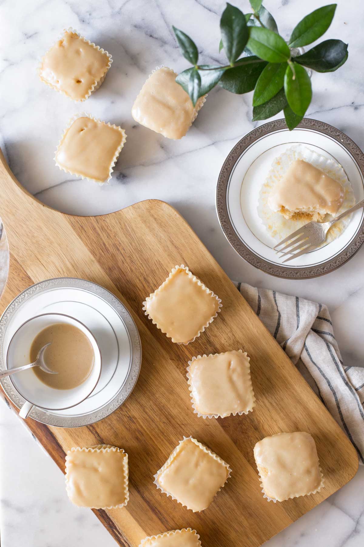 An overhead view of a copycat version of Martino's Bakery Tea Cakes on a wooden cutting board. 