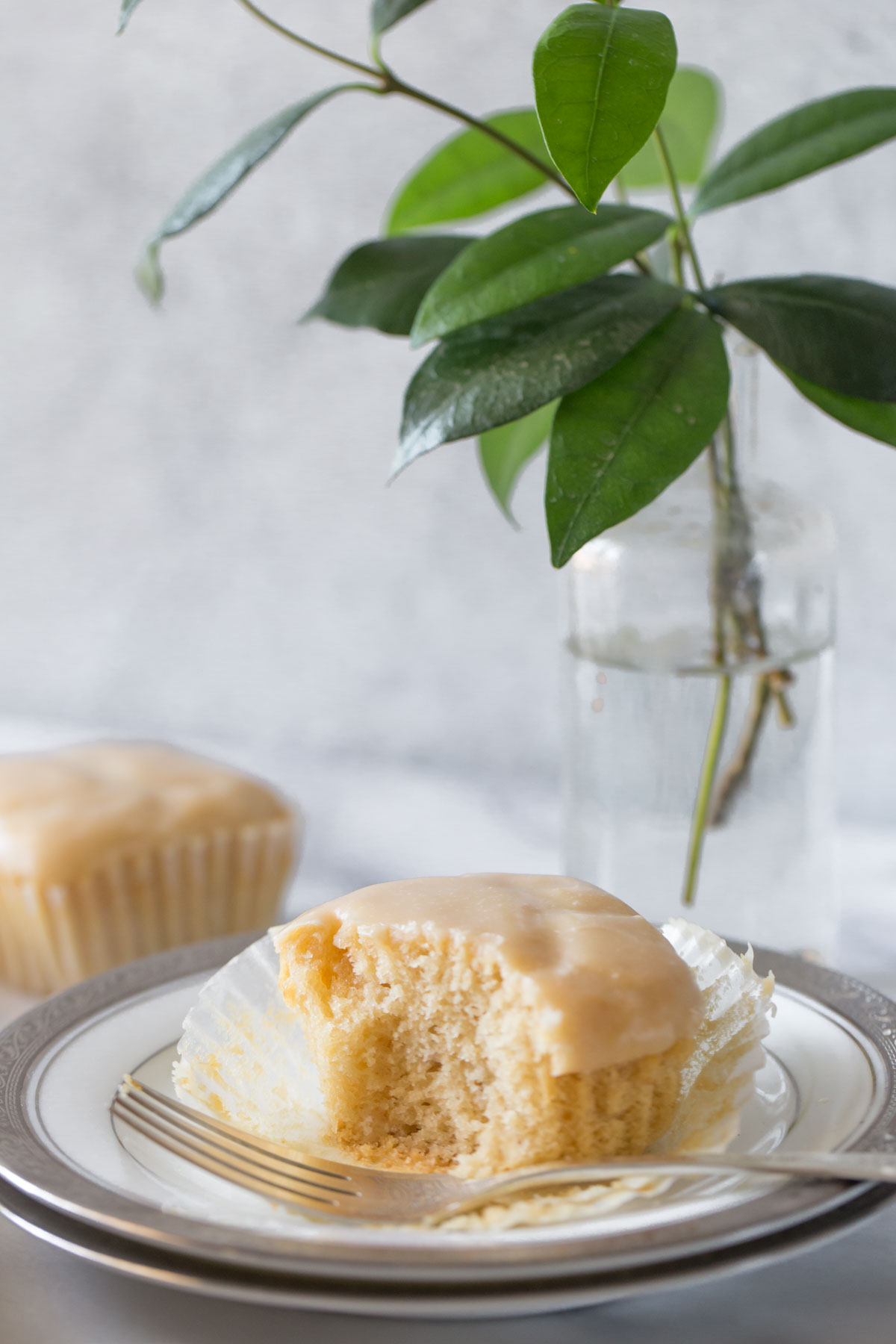 A close up view of a copycat version of Martino's Bakery Tea Cakes on a white plate with a grey background. 