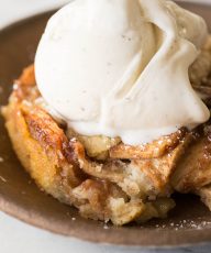 Close up view of Apple Cobbler with a scoop of vanilla ice cream on top.