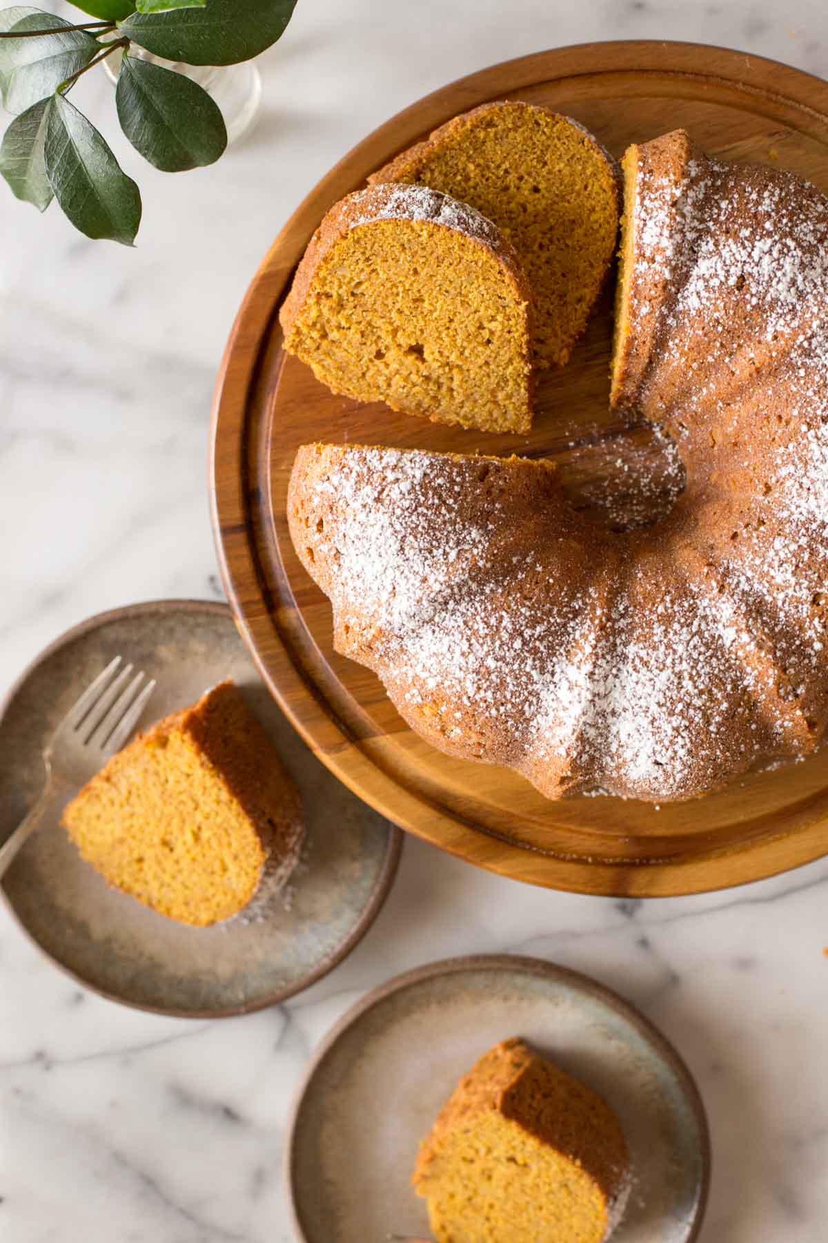 Overhead view of Apple Pumpkin Cake on a wooden cake stand. 