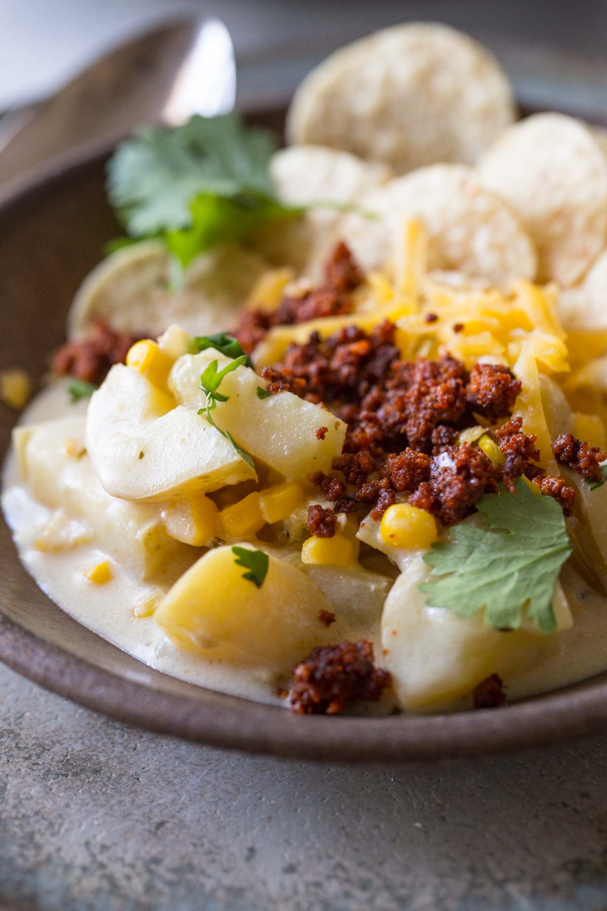 Close in shot of Creamy Corn Chowder With Chorizo, topped with cilantro and cheese. 