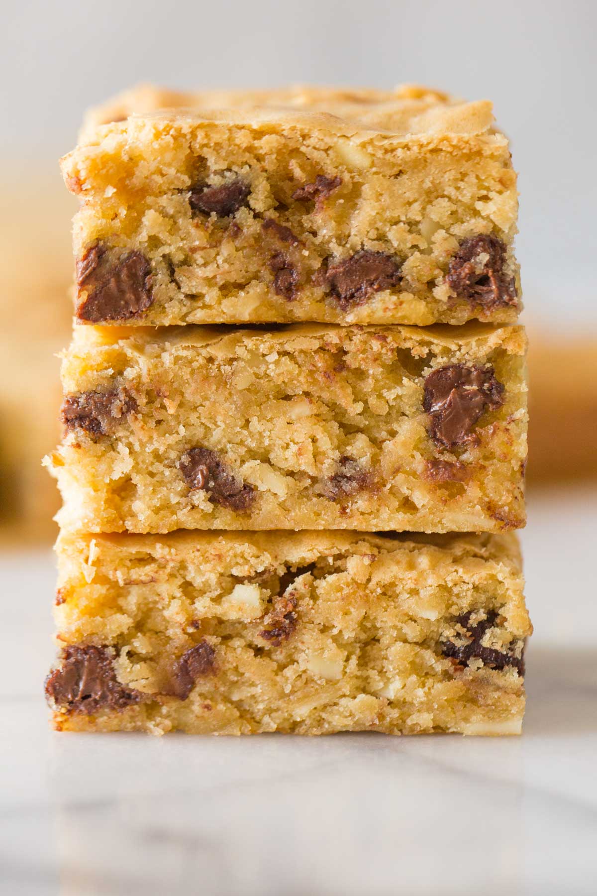 Close up shot of inside of cut Easy One Bowl Blondies stacked three in a row. 