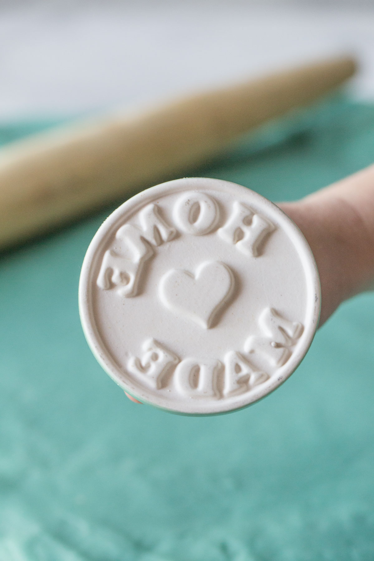 Close up view of playdough stamp that says home made. 