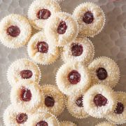 Overhead view of Mini Raspberry Almond Tarts on a sliver tray.