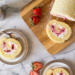 Overhead view of Vanilla Roll Cake sliced and served.