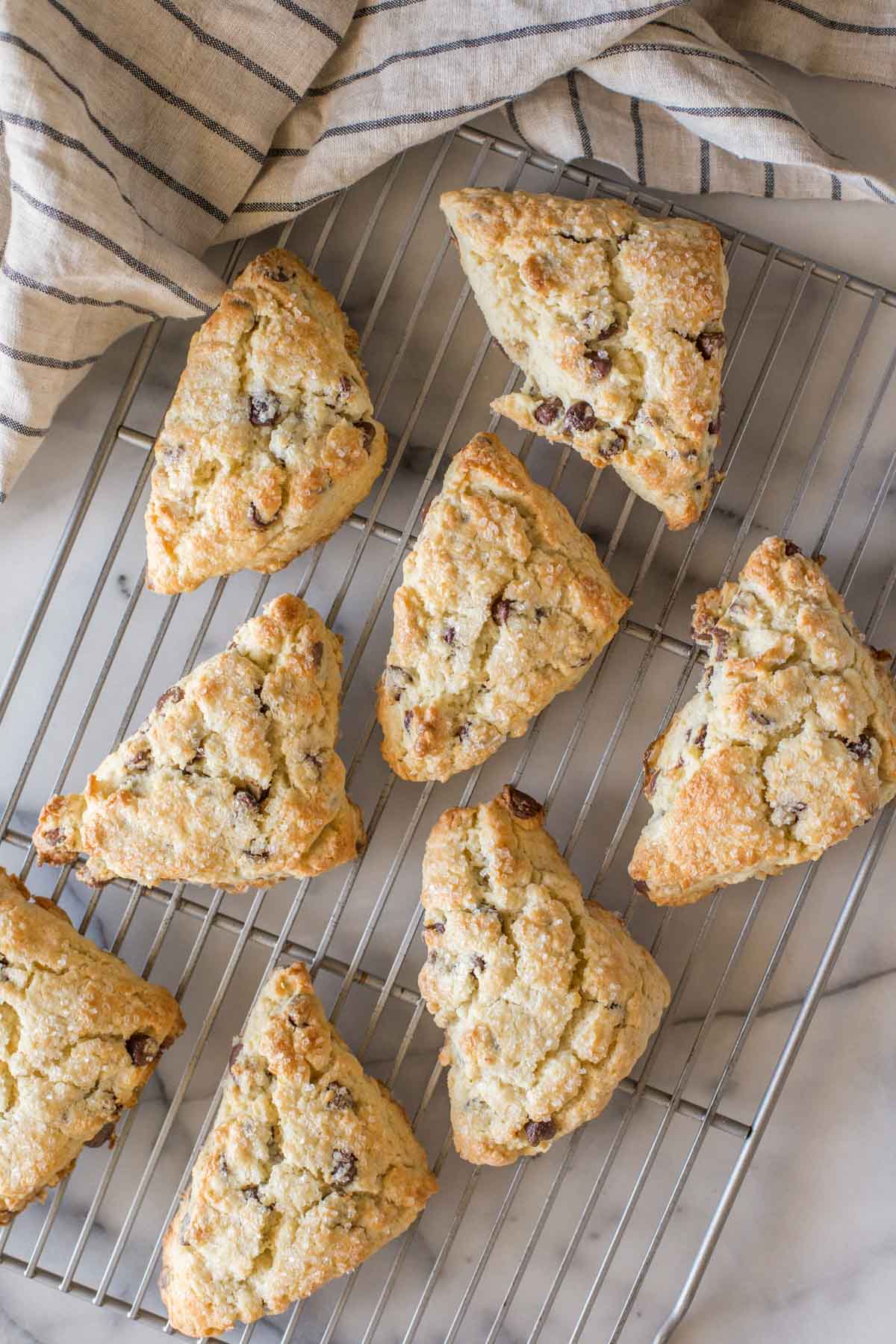 Overhead shot of Chocolate Chip Scones on a cooling rack with a marble background.  