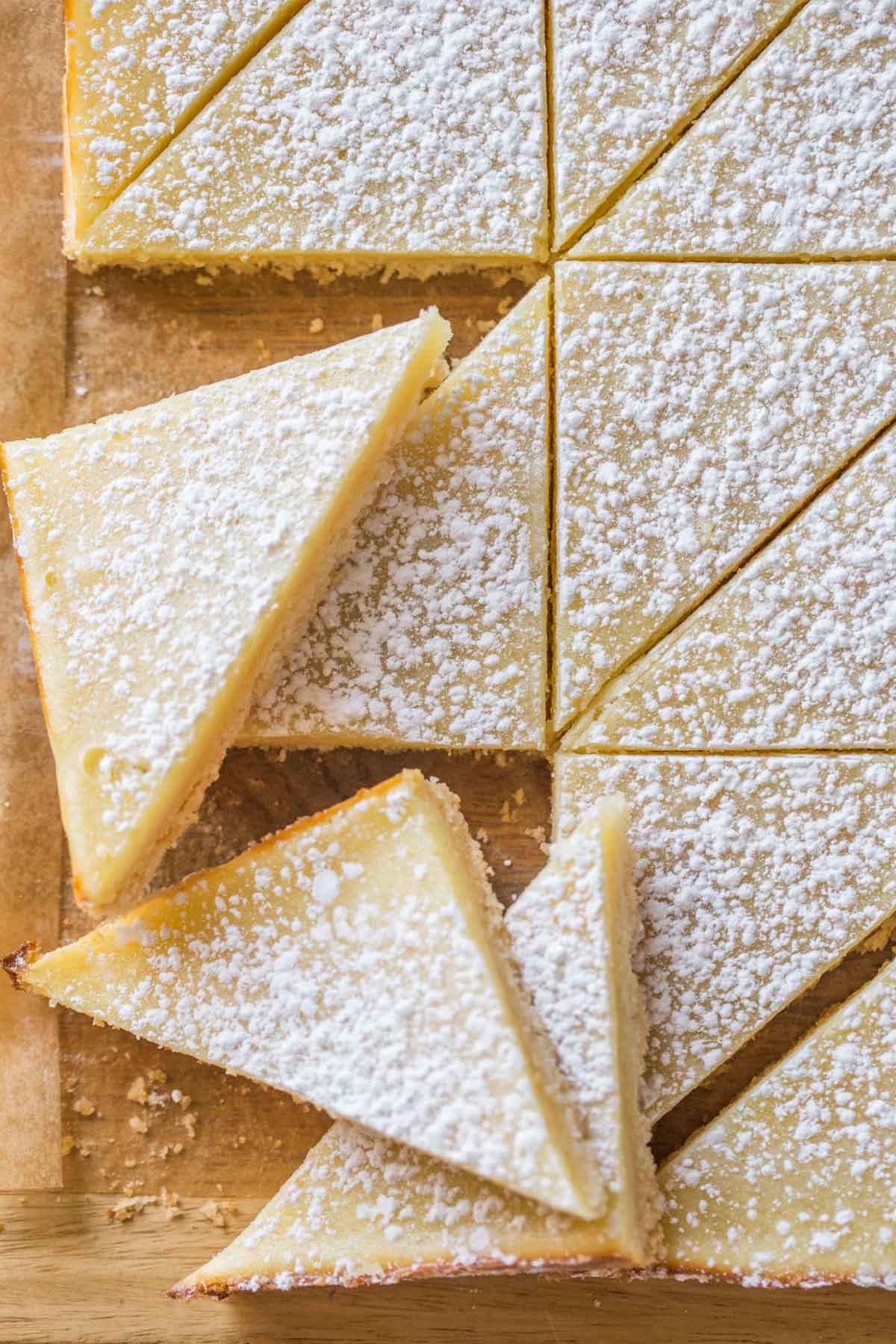Overhead view of Swedish Lemon Bars on a wooden cutting board. 