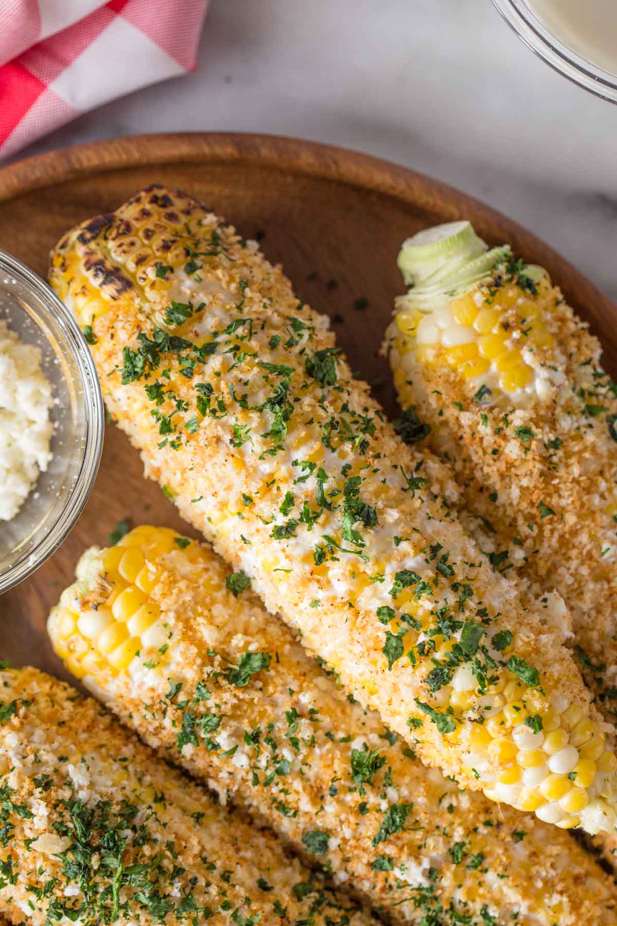 Overhead shot of Mexican Street Corn With Panko on a wood platter. 