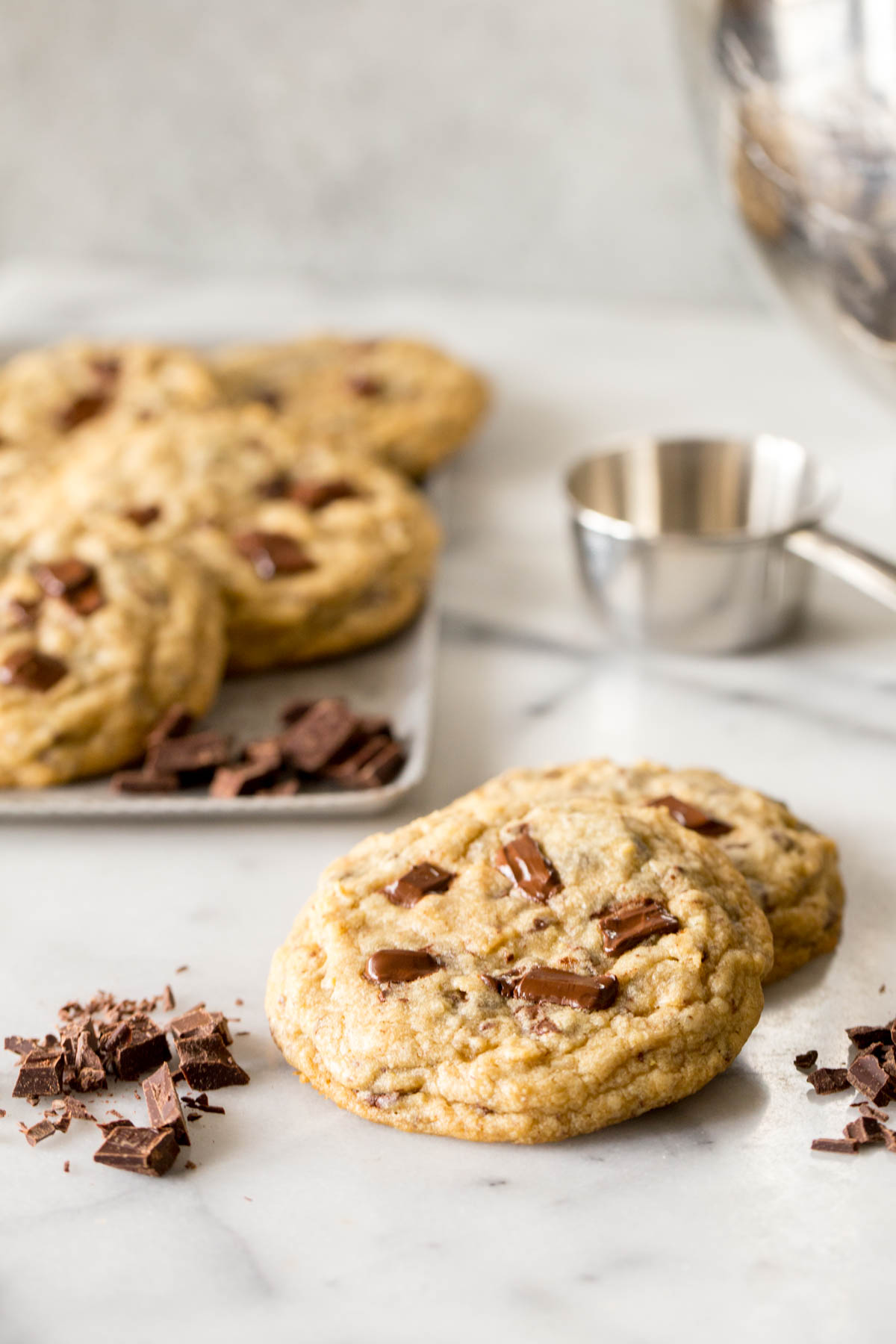 Two stacked Perfect Chocolate Chunk Cookies, with more cookies in the background.  