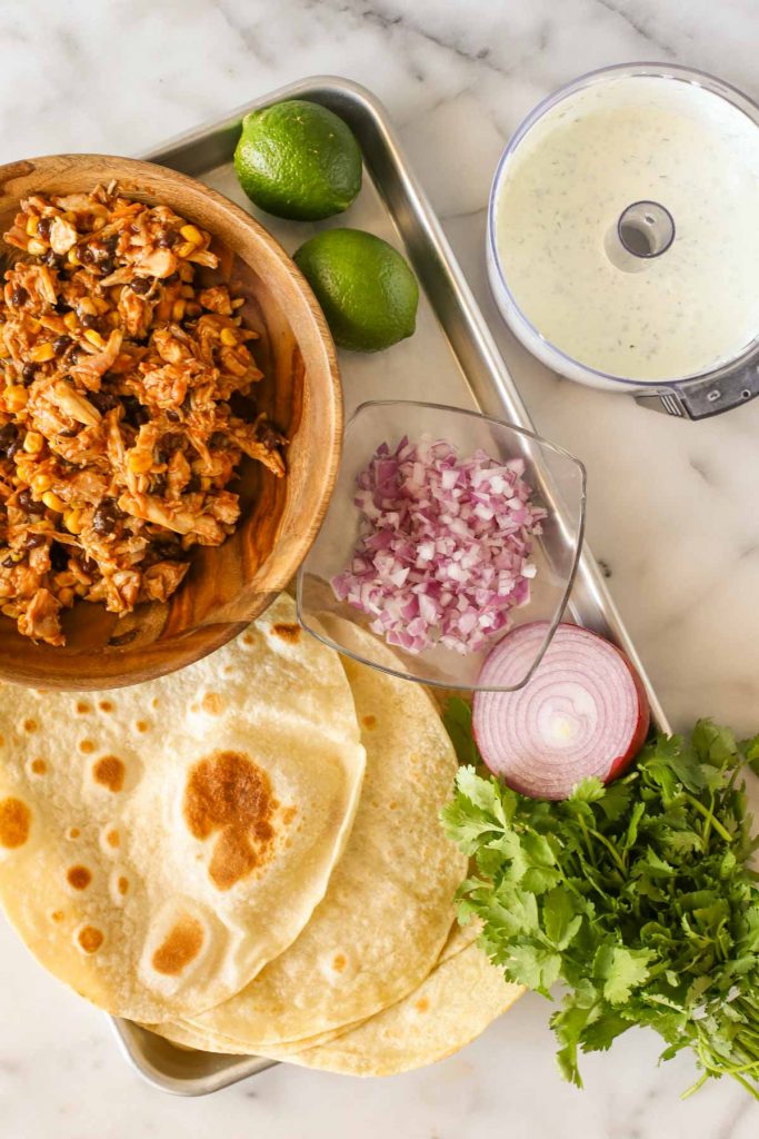 Overhead shot of all the prepared ingredients needed to assemble the BBQ Chicken Taquitos.  