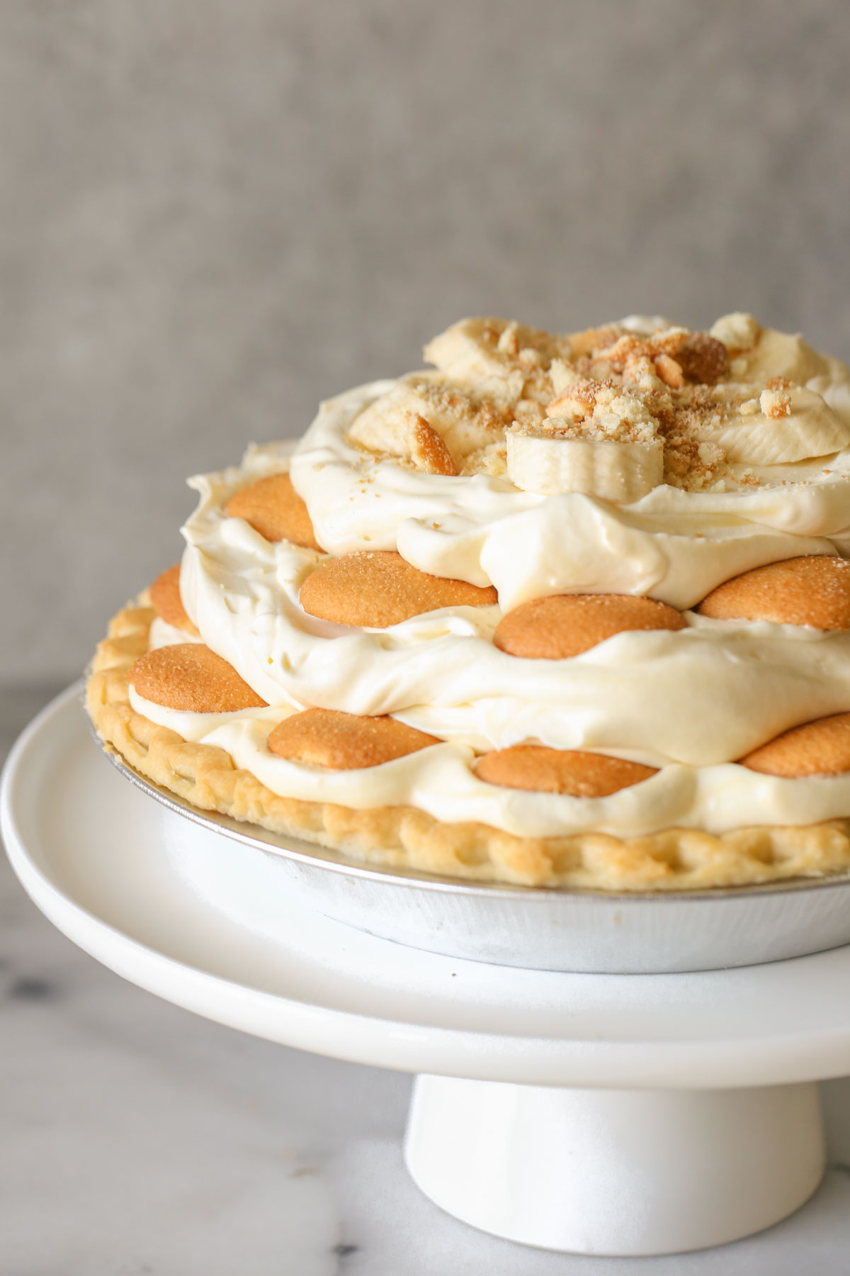 Mile High Banana Pudding Pie on a white cake stand. 